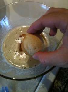 Dipping and rolling on all sides, letting excess drip off